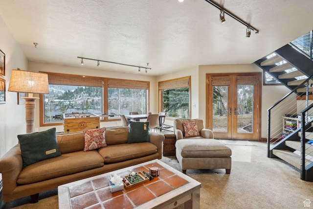 1386 Pinnacle Dr Unit 82, Park City, UT 84060 - living area with rail lighting, carpet floors, a textured ceiling, and french doors