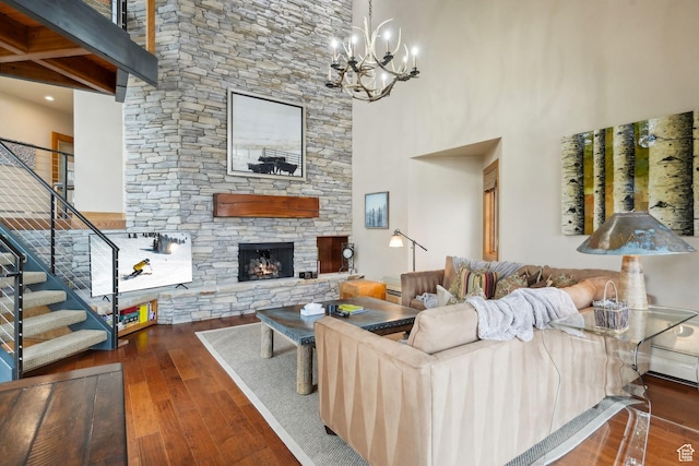 1386 Pinnacle Dr Unit 82, Park City, UT 84060 - living room with wood-type flooring, a stone fireplace, stairs, a towering ceiling, and a chandelier