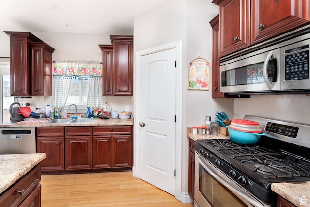 4231 W 650 N, Vernal, UT 84078 - kitchen with light wood-style floors, a sink, light stone countertops, and stainless steel appliances