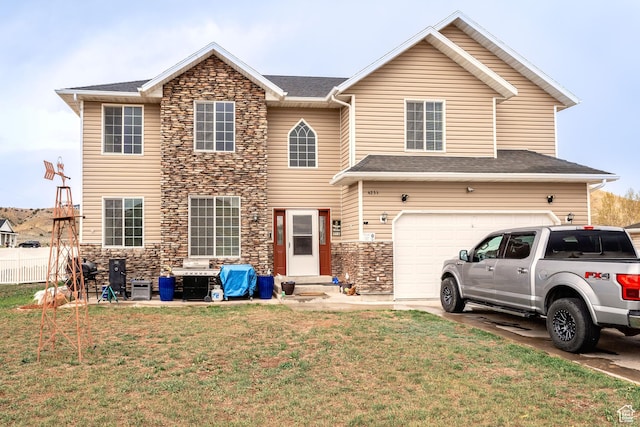 4231 W 650 N, Vernal, UT 84078 - view of front of home featuring a front lawn, stone siding, a garage, entry steps, and concrete driveway