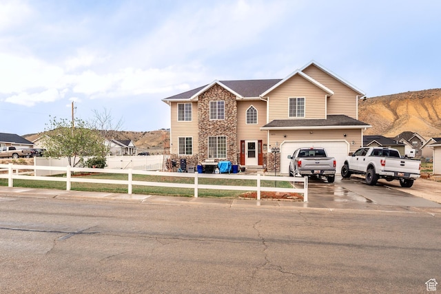 4231 W 650 N, Vernal, UT 84078 - traditional home featuring stone siding, a garage, a mountain view, concrete driveway, and fence private yard