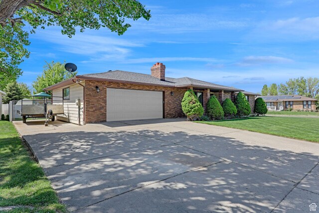 2137 W 550 N, West Point, UT 84015 - ranch-style home with a front lawn, brick siding, a garage, a chimney, and driveway