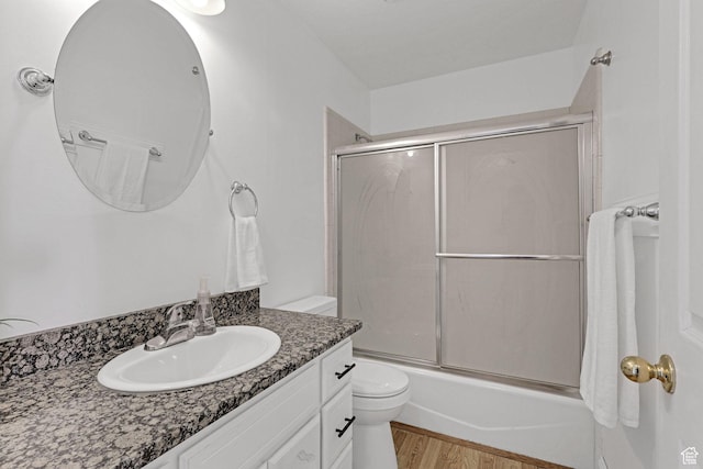 2137 W 550 N, West Point, UT 84015 - bathroom with toilet, wood finished floors, bath / shower combo with glass door, and vanity