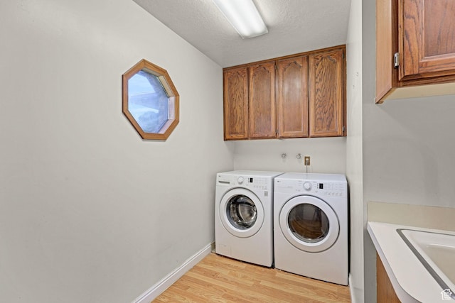2137 W 550 N, West Point, UT 84015 - washroom featuring washer and dryer, light wood-style floors, baseboards, a sink, and cabinet space