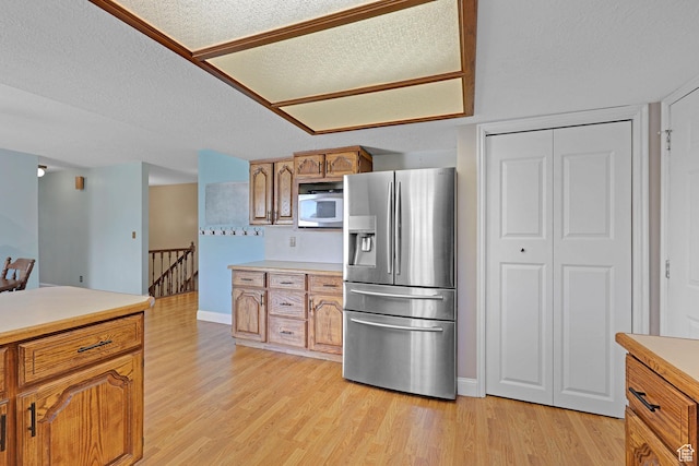 2137 W 550 N, West Point, UT 84015 - kitchen featuring brown cabinets, light countertops, baseboards, stainless steel fridge, and light wood-style flooring
