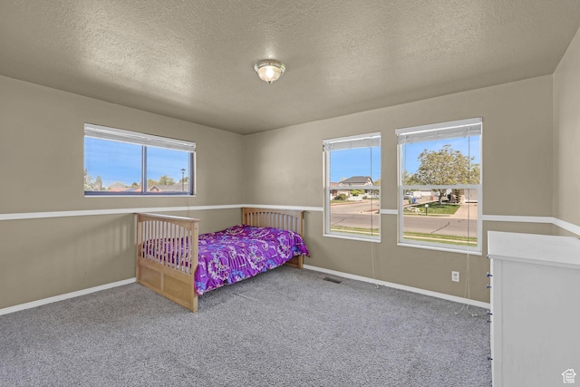 2137 W 550 N, West Point, UT 84015 - bedroom featuring carpet floors, baseboards, a textured ceiling, and visible vents