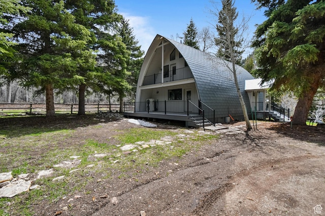 8180 E Pine Way, Oakley, UT 84055 - exterior space with fence, a balcony, and a gambrel roof