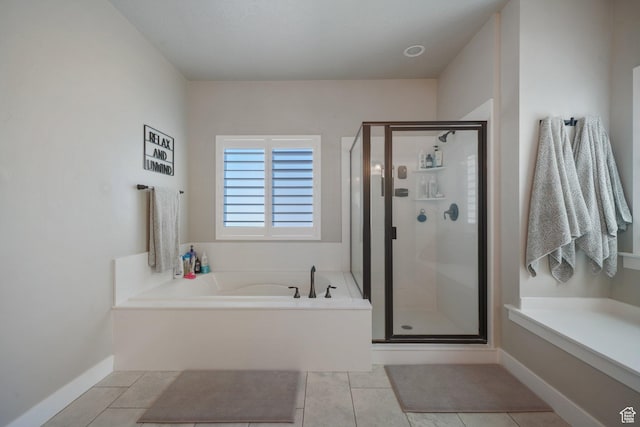 bathroom with a bath, tile patterned floors, and a shower stall