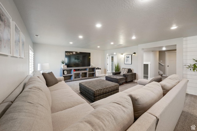 living room featuring recessed lighting, carpet, stairs, and visible vents