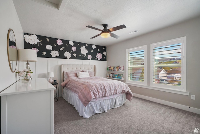 bedroom with a textured ceiling, visible vents, light carpet, and wallpapered walls