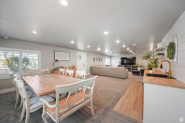 dining room featuring carpet floors and recessed lighting