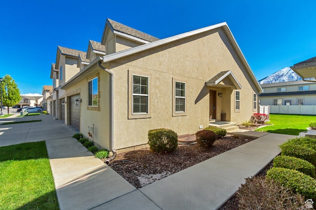 1155 S 2880 E, Spanish Fork, UT 84660 - view of front of property with fence, a shingled roof, a front lawn, stucco siding, and driveway