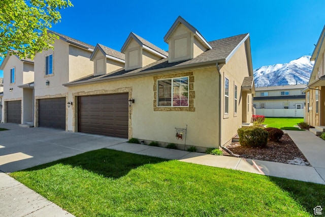 1155 S 2880 E, Spanish Fork, UT 84660 - view of property with an attached garage, stucco siding, a front yard, a mountain view, and driveway