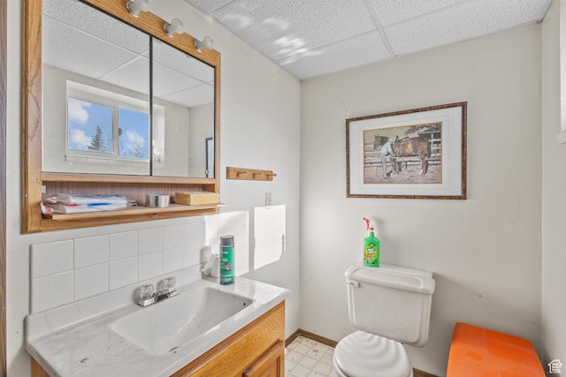 1745 Old Ranch Rd, Park City, UT 84098 - half bathroom with vanity, toilet, baseboards, a drop ceiling, and tile patterned floors