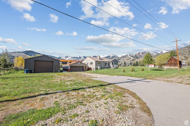 1745 Old Ranch Rd, Park City, UT 84098 - view of front of house featuring a garage, a front lawn, a mountain view, and fence