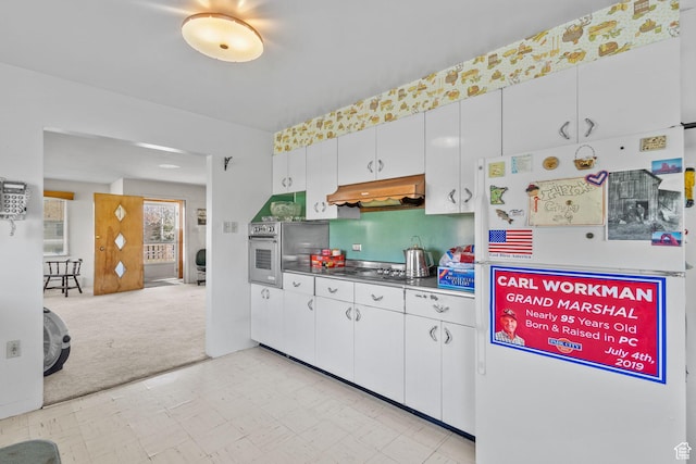 1745 Old Ranch Rd, Park City, UT 84098 - kitchen featuring white cabinets, under cabinet range hood, light floors, light carpet, and stainless steel appliances