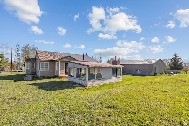 1745 Old Ranch Rd, Park City, UT 84098 - rear view of property featuring a yard, a chimney, a sunroom, and metal roof