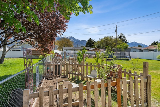 222 N 600th St E, Orem, UT 84097 - view of yard featuring a mountain view, a fenced backyard, and a trampoline