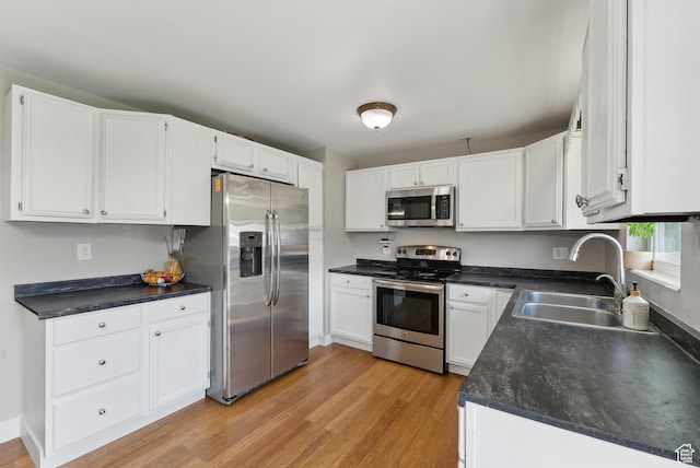 222 N 600th St E, Orem, UT 84097 - kitchen with a sink, white cabinets, stainless steel appliances, and light wood-type flooring