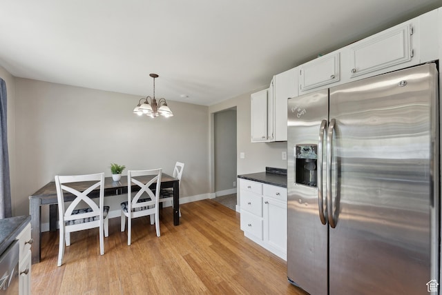 222 N 600th St E, Orem, UT 84097 - kitchen featuring dark countertops, a notable chandelier, light wood finished floors, white cabinetry, and stainless steel refrigerator with ice dispenser