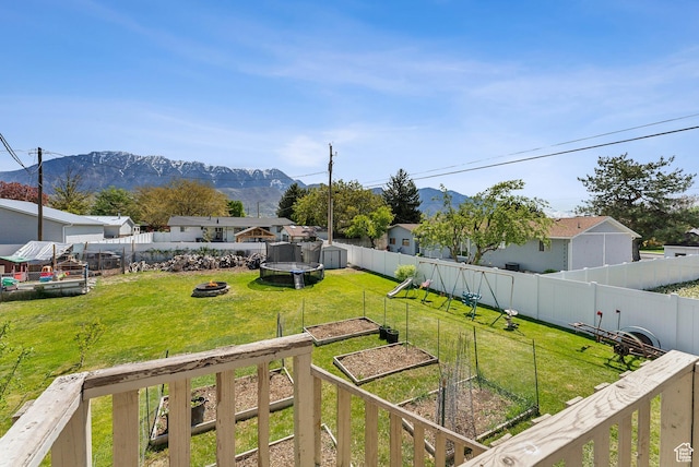 222 N 600th St E, Orem, UT 84097 - view of yard featuring a garden, a mountain view, a fenced backyard, and an outdoor fire pit