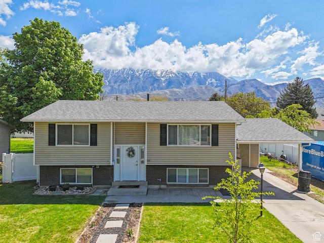 222 N 600th St E, Orem, UT 84097 - raised ranch with brick siding, fence, a mountain view, a front lawn, and concrete driveway