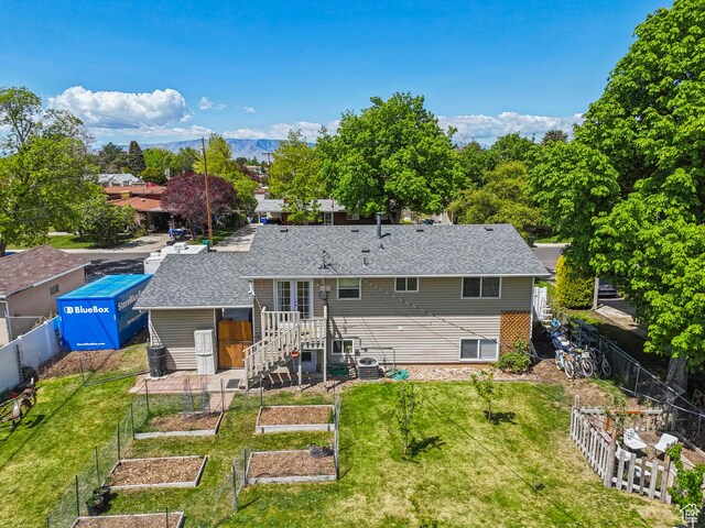 222 N 600th St E, Orem, UT 84097 - rear view of property featuring a lawn, a garden, and a fenced backyard