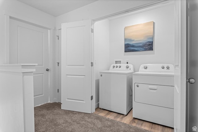 laundry room with laundry area, light colored carpet, and washer and clothes dryer