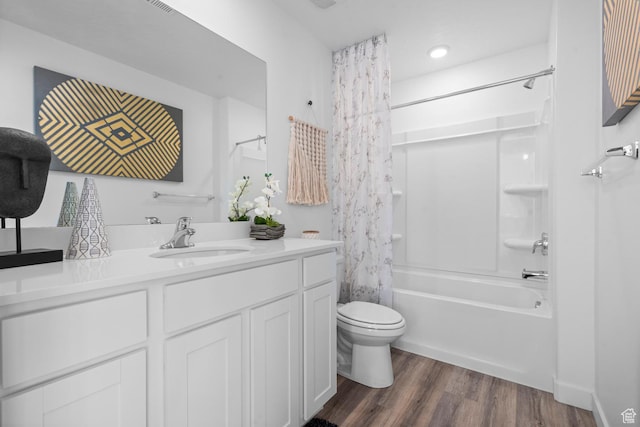 bathroom featuring vanity, shower / bathtub combination with curtain, wood finished floors, and toilet