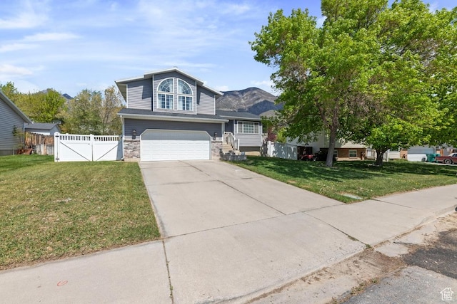 10046 N Sage Rd W, Cedar Hills, UT 84062 - view of front of house with driveway, a gate, a garage, fence, and a front lawn