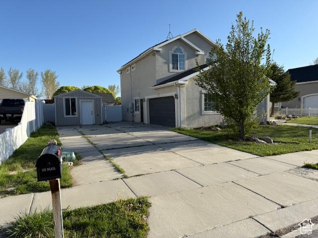 1334 E Harrier St, Eagle Mountain, UT 84005 - traditional-style home featuring concrete driveway, an attached garage, fence, and stucco siding