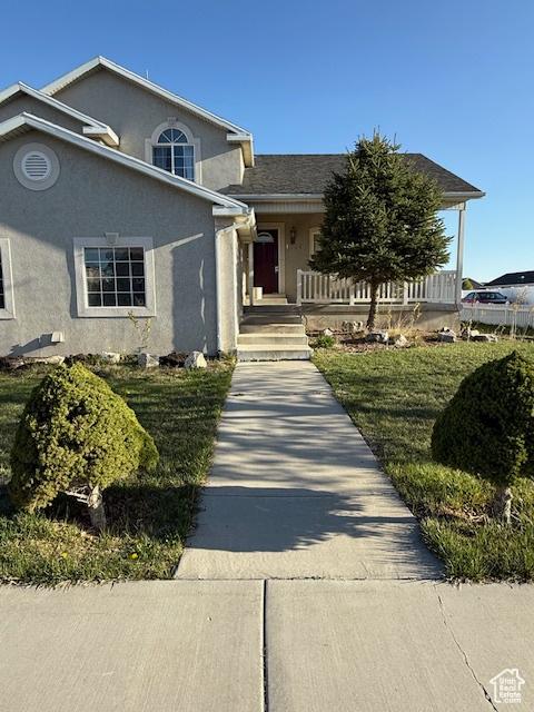 1334 E Harrier St, Eagle Mountain, UT 84005 - view of front of house with covered porch and stucco siding
