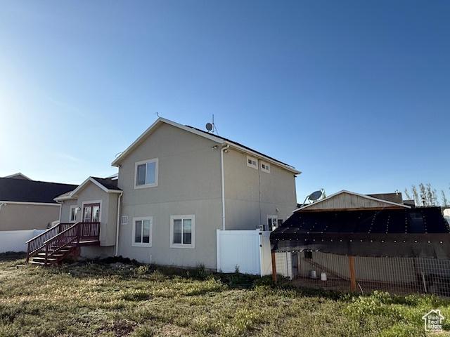 1334 E Harrier St, Eagle Mountain, UT 84005 - rear view of property with stucco siding and fence