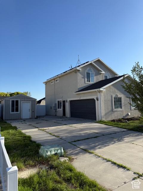 1334 E Harrier St, Eagle Mountain, UT 84005 - view of property exterior with a garage, an outbuilding, stucco siding, and concrete driveway