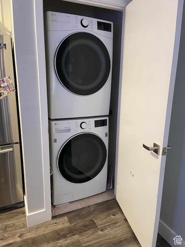 1206 E Waterside Cv Unit 21, Cottonwood Heights, UT 84047 - washroom featuring stacked washer and dryer, laundry area, and wood finished floors