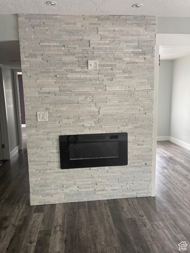 1206 E Waterside Cv Unit 21, Cottonwood Heights, UT 84047 - room details featuring baseboards, a fireplace, a textured ceiling, and wood finished floors