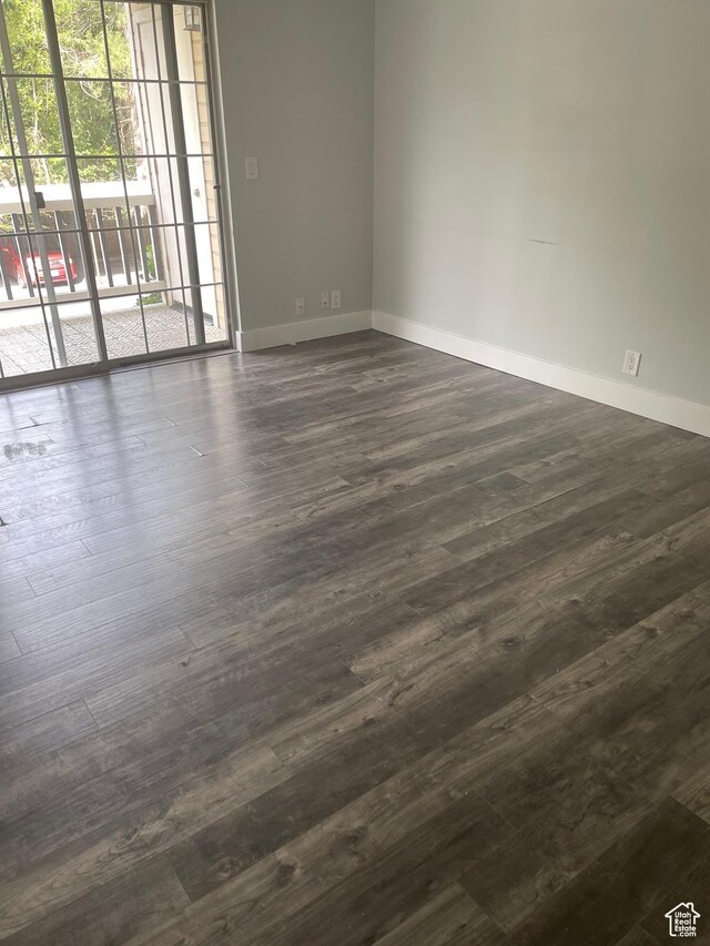 1206 E Waterside Cv Unit 21, Cottonwood Heights, UT 84047 - spare room featuring baseboards and dark wood-style flooring