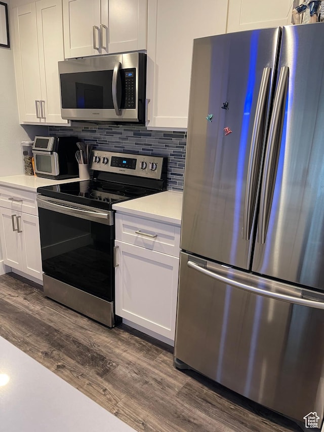 1206 E Waterside Cv Unit 21, Cottonwood Heights, UT 84047 - kitchen featuring white cabinets, appliances with stainless steel finishes, light countertops, decorative backsplash, and dark wood-type flooring