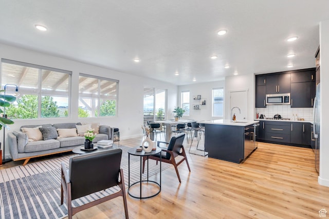 6294 W 7830 S, West Jordan, UT 84081 - living area featuring recessed lighting, baseboards, and light wood-style flooring