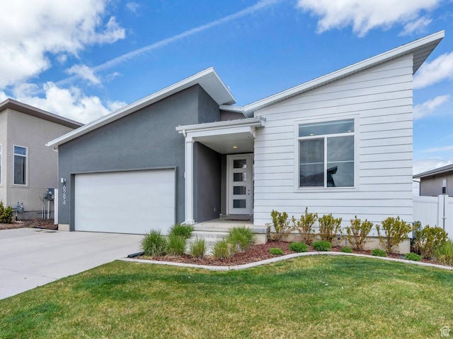 view of front of home featuring a garage, fence, concrete driveway, and a front lawn