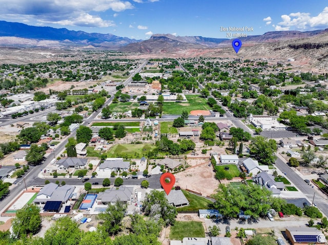 drone / aerial view featuring a residential view and a mountain view