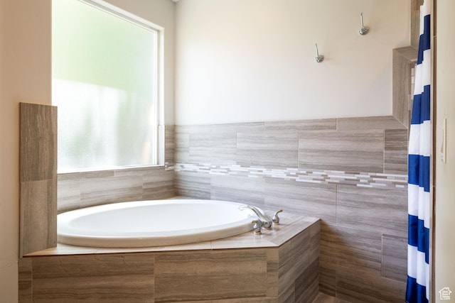 full bathroom featuring a bath and curtained shower