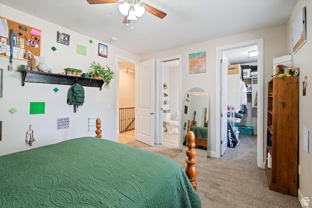 bedroom featuring carpet flooring, ensuite bath, a ceiling fan, a spacious closet, and a closet