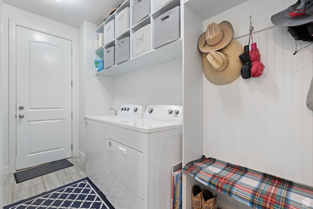 clothes washing area with separate washer and dryer and laundry area