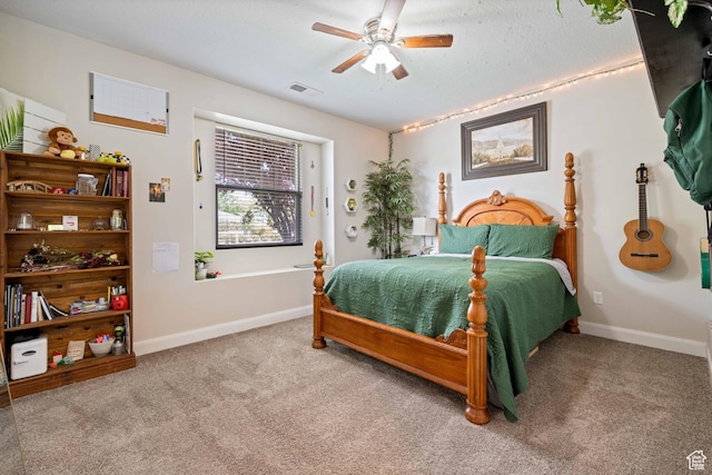 bedroom with baseboards, a ceiling fan, carpet flooring, and visible vents