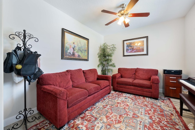 living room featuring light wood-style floors and a ceiling fan