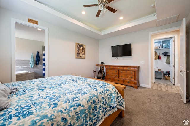 bedroom featuring a ceiling fan, visible vents, recessed lighting, a tray ceiling, and carpet flooring