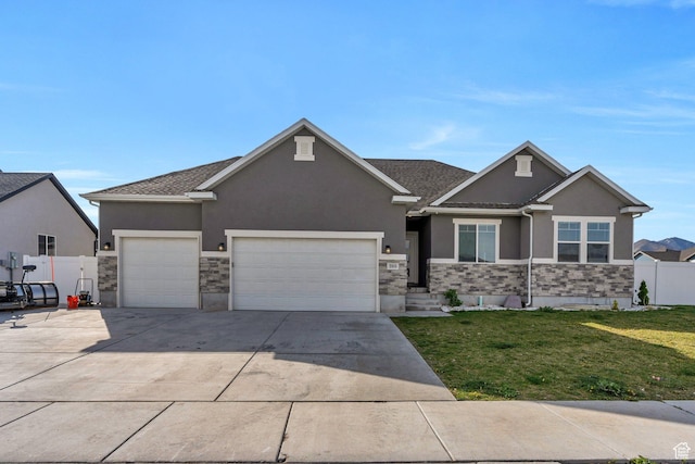 289 W Lauren N, Tooele, UT 84074 - view of front of house with fence, an attached garage, stucco siding, a front yard, and concrete driveway