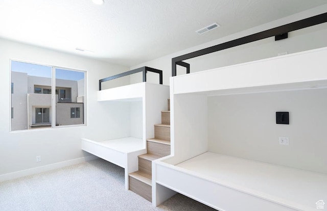 unfurnished bedroom featuring carpet flooring, baseboards, and visible vents