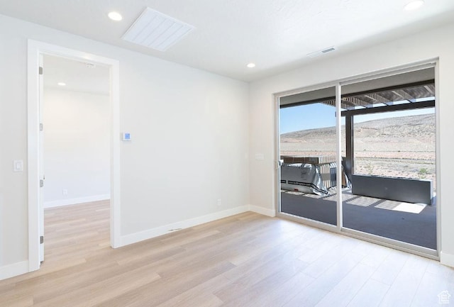 spare room with recessed lighting, baseboards, and light wood-type flooring